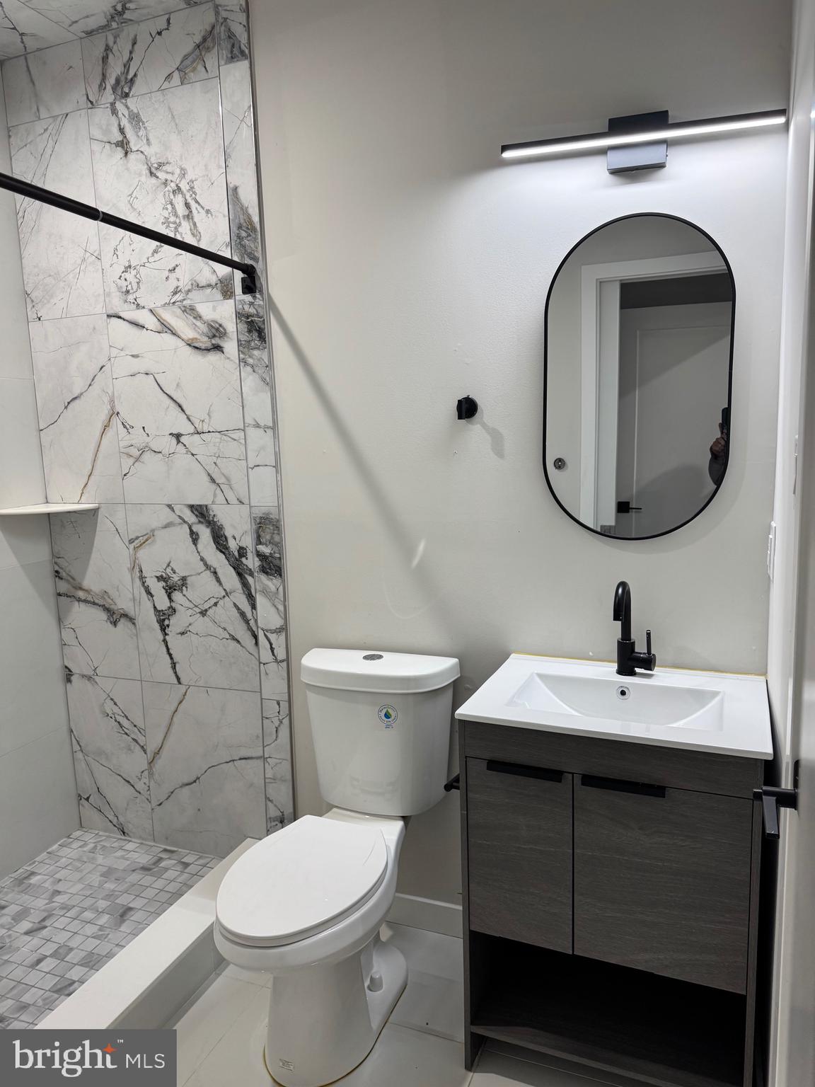 2256 North 9th Street, Unit 1 Philadelphia, PA 19133 - Photo 29 of 29 a bathroom with a sink toilet and mirror