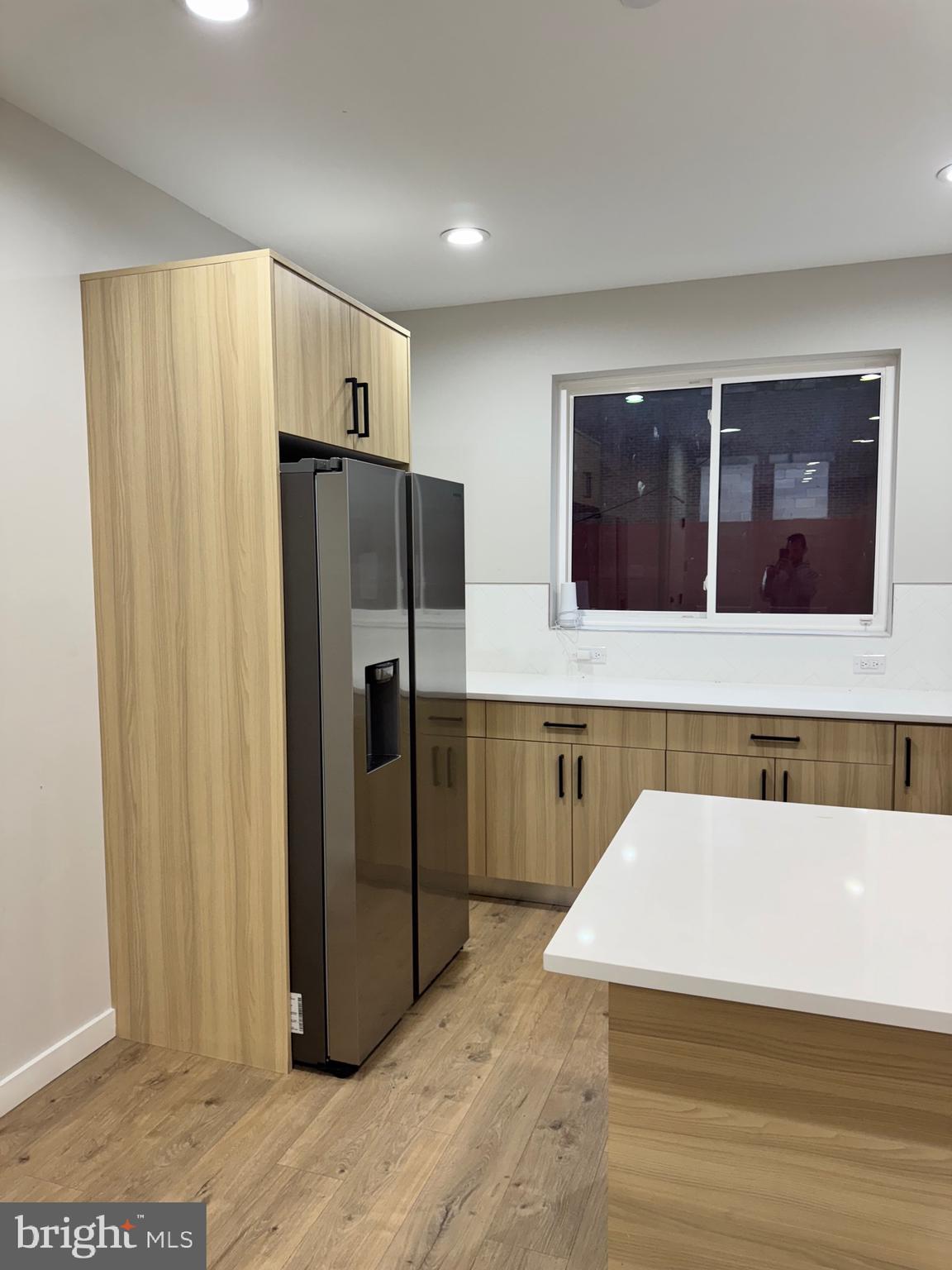 2256 North 9th Street, Unit 1 Philadelphia, PA 19133 - Photo 4 of 29 a view of a refrigerator in kitchen and wooden floor