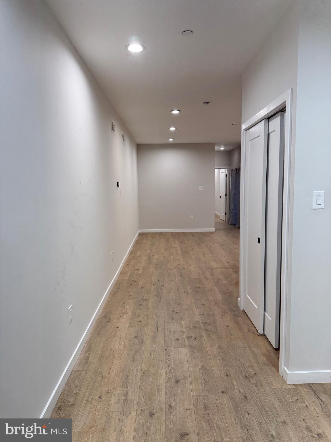 2256 North 9th Street, Unit 1 Philadelphia, PA 19133 - Photo 8 of 29 an empty room with wooden floor and windows