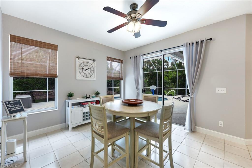697 Crossfield Circle Naples, FL 34104 - Photo 9 of 18 Dining room featuring ceiling fan and light tile patterned floors