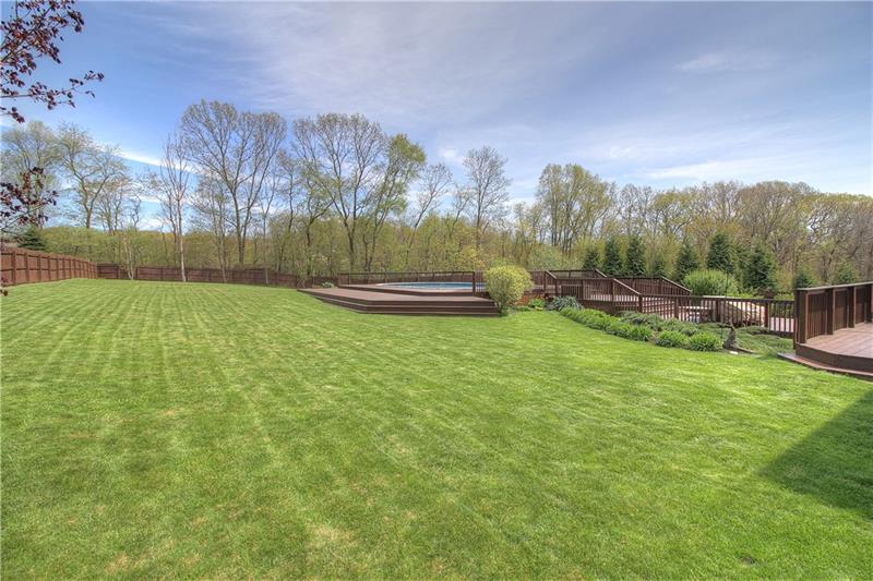 105 Rochelle Lane Monaca, PA 15061 - Photo 22 of 25 View of the back yard from the left front corner. The entire yard is already fenced for your pets, level and usable. Located through the rear fence is a large shed allowing you to store lawn equipment out of sight.