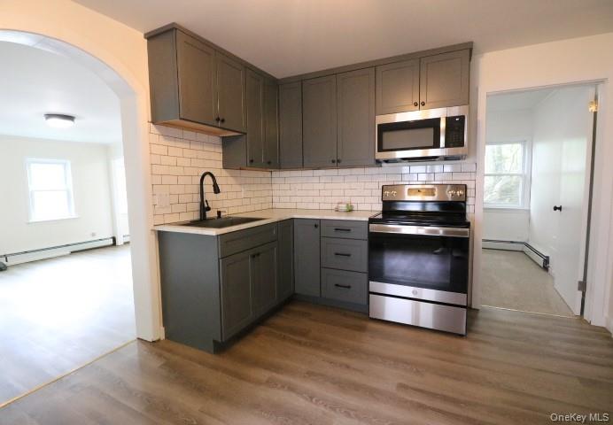 208 Center Street Ellenville, NY 12428 - Photo 3 of 13 a kitchen with stainless steel appliances a stove microwave and sink