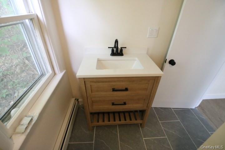 208 Center Street Ellenville, NY 12428 - Photo 8 of 13 a bathroom with a sink and a mirror