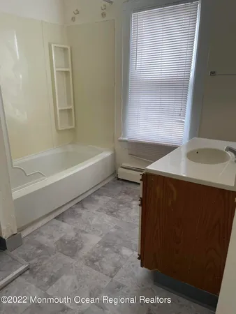 a spacious bathroom with a sink and a bathtub