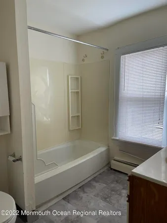 a bathroom with a glass shower door and a bathtub