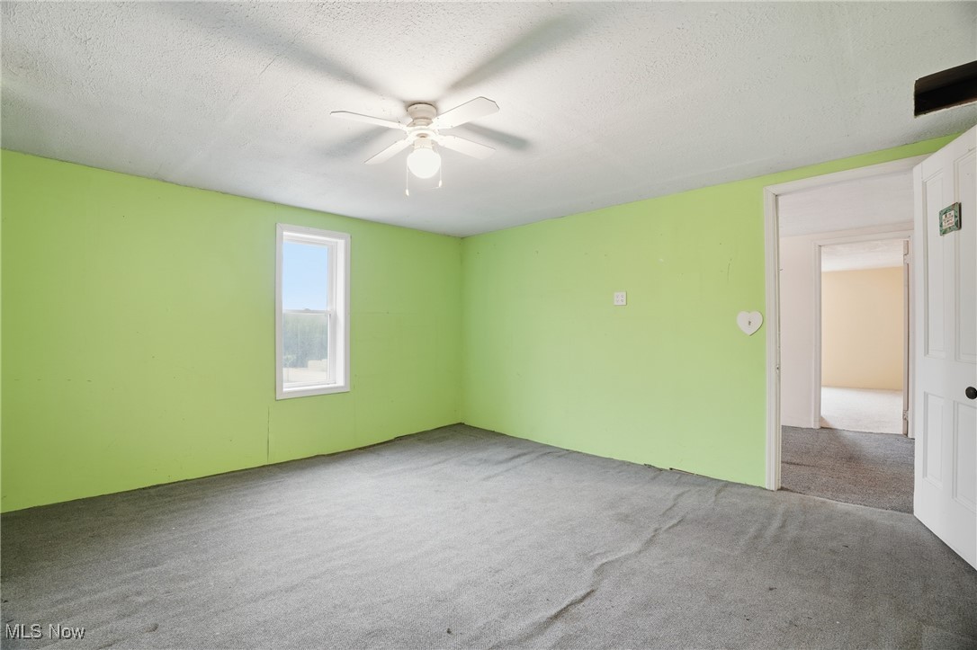 8045 Veto Road Belpre, OH 45714 - Photo 45 of 50 Carpeted empty room with a textured ceiling and a ceiling fan