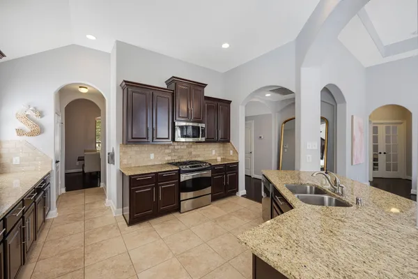 a large kitchen with stainless steel appliances and a stove
