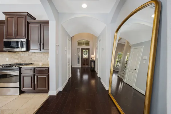 a kitchen with stainless steel appliances kitchen island granite countertop a refrigerator and a stove top oven