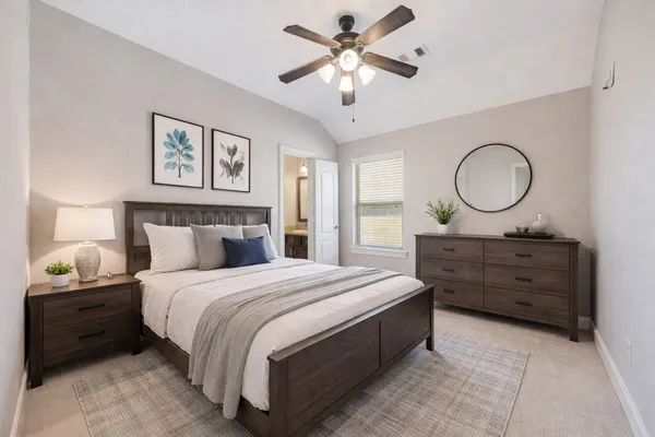 a bedroom with a bed and a chandelier