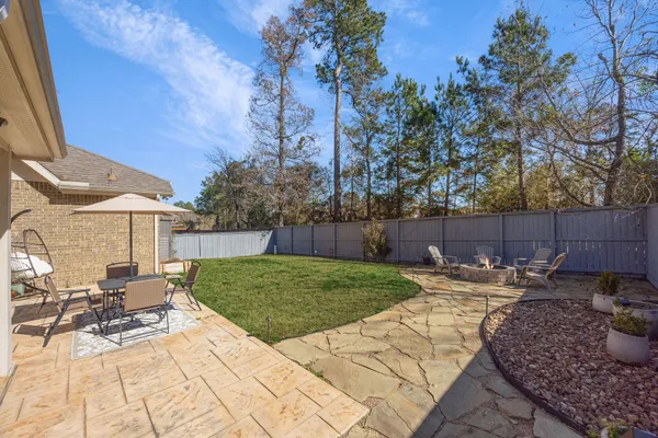 a view of backyard with wooden fence