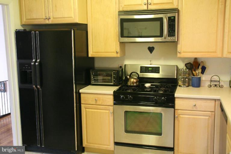 5705 Ashfield Road Alexandria, VA 22315 - Photo 2 of 28 a kitchen with a stove and a microwave