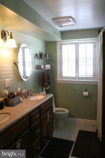 5705 Ashfield Road Alexandria, VA 22315 - Photo 15 of 28 a bathroom with a sink and a mirror