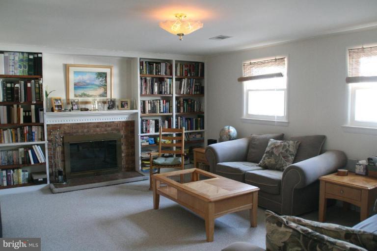 5705 Ashfield Road Alexandria, VA 22315 - Photo 16 of 28 a living room with furniture and a fireplace