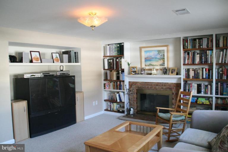 5705 Ashfield Road Alexandria, VA 22315 - Photo 17 of 28 a living room with furniture and a fireplace