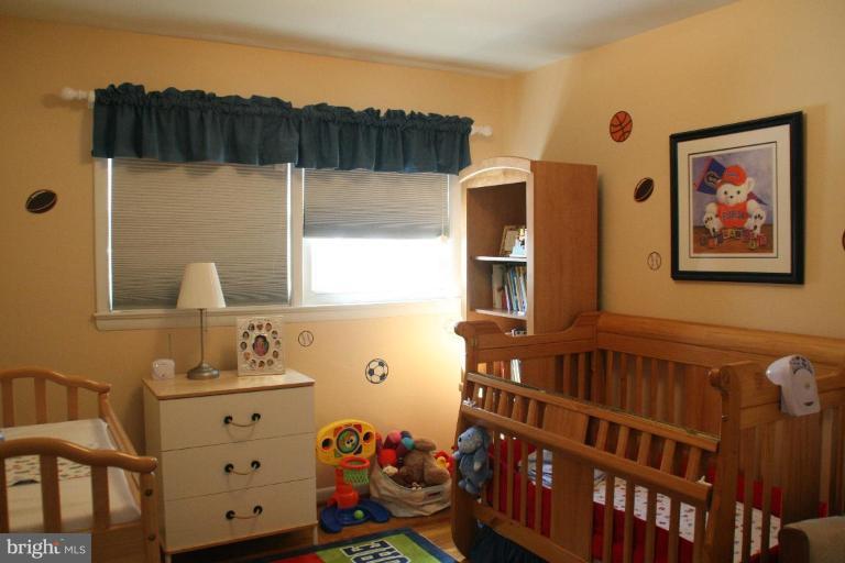 5705 Ashfield Road Alexandria, VA 22315 - Photo 18 of 28 a view of a bedroom with baby crib and dresser