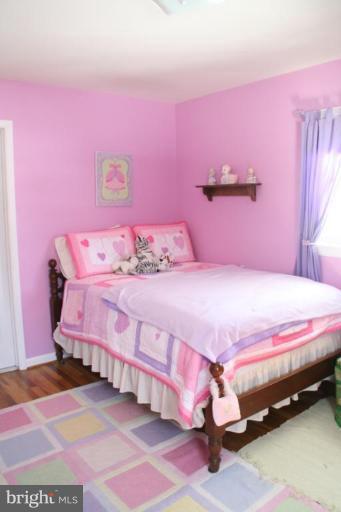 5705 Ashfield Road Alexandria, VA 22315 - Photo 20 of 28 a bedroom with pink walls