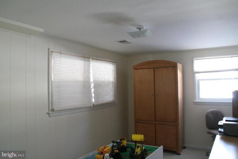 5705 Ashfield Road Alexandria, VA 22315 - Photo 21 of 28 a room with a window and wooden door