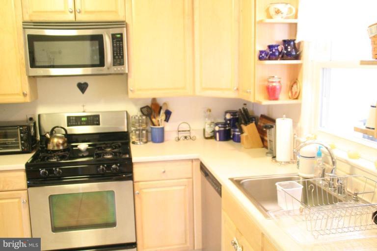 5705 Ashfield Road Alexandria, VA 22315 - Photo 4 of 28 a kitchen with granite countertop a stove a sink and a microwave