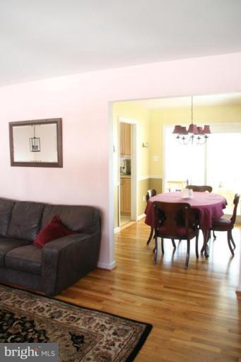 5705 Ashfield Road Alexandria, VA 22315 - Photo 7 of 28 a living room with furniture and a wooden floor