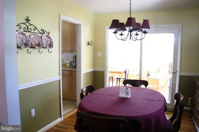 5705 Ashfield Road Alexandria, VA 22315 - Photo 9 of 28 a view of a dining room with furniture and a chandelier
