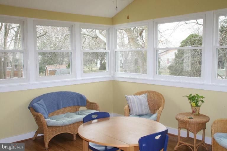 5705 Ashfield Road Alexandria, VA 22315 - Photo 10 of 28 a kitchen with a table chairs and wooden floor