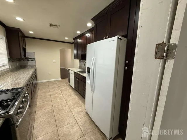 a kitchen with a refrigerator and a sink