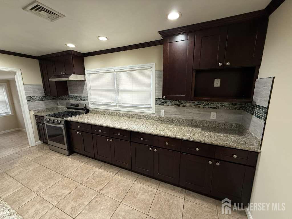 4 Rachel Terrace Piscataway, NJ 08854 - Photo 16 of 23 a kitchen with stainless steel appliances granite countertop wooden cabinets a stove top oven a sink and dishwasher