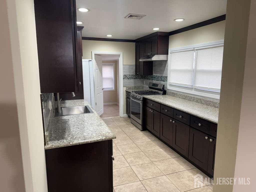 4 Rachel Terrace Piscataway, NJ 08854 - Photo 21 of 23 a kitchen with stainless steel appliances granite countertop a sink counter space cabinets and a counter top space