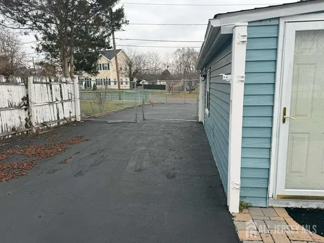 a view of a yard with wooden fence