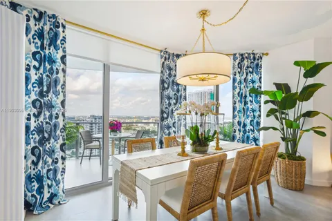 a dining room with furniture a chandelier and wooden floor