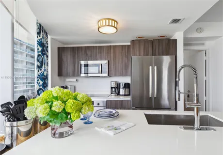 a kitchen with a refrigerator and a sink