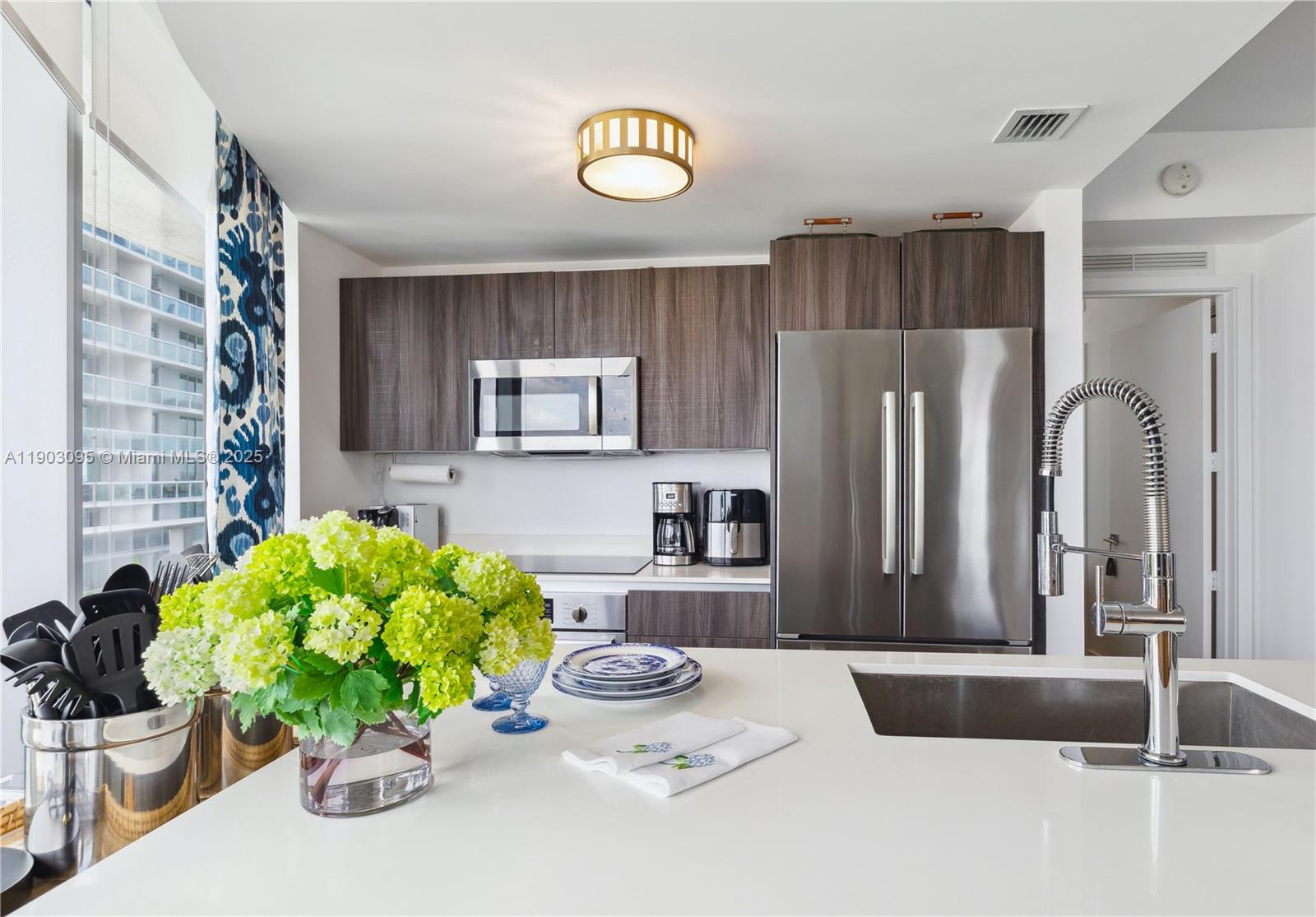 488 Northeast 18th Street, Unit 2301 Miami, FL 33132 - Photo 16 of 43 a kitchen with a refrigerator and a sink