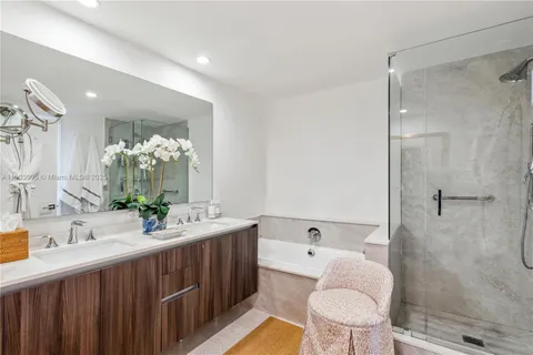 a bathroom with a double vanity sink toilet and shower