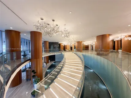 a lobby with furniture and stairs