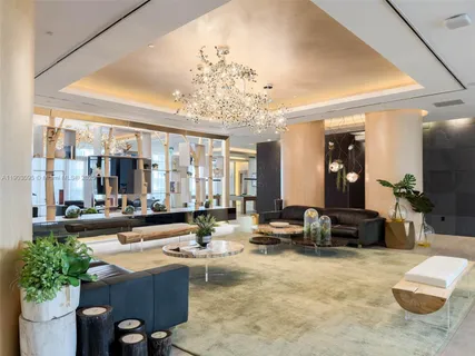 a large living room with furniture and a large window