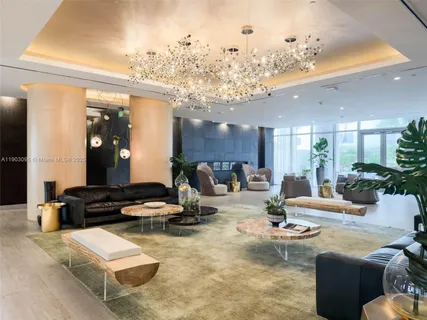 a living room with furniture and a chandelier