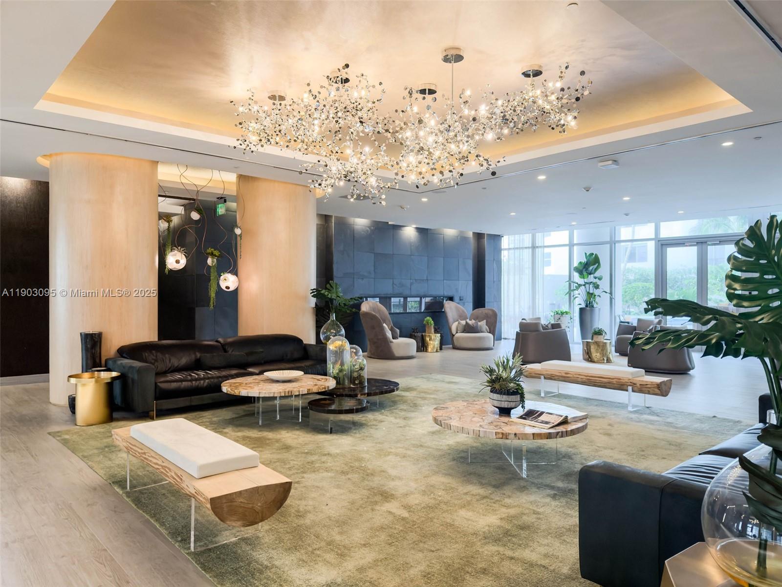 488 Northeast 18th Street, Unit 2301 Miami, FL 33132 - Photo 24 of 43 a living room with furniture and a chandelier