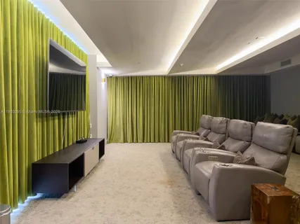 a balcony with furniture and a book shelf