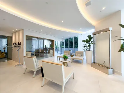 a view of a living room kitchen with furniture and a large window