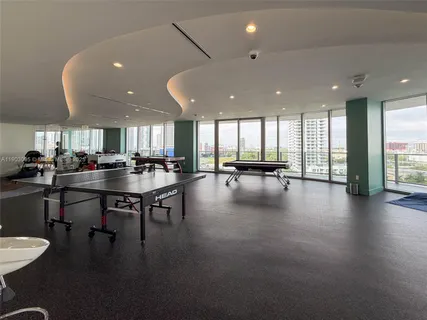 a lobby with furniture and a floor to ceiling window