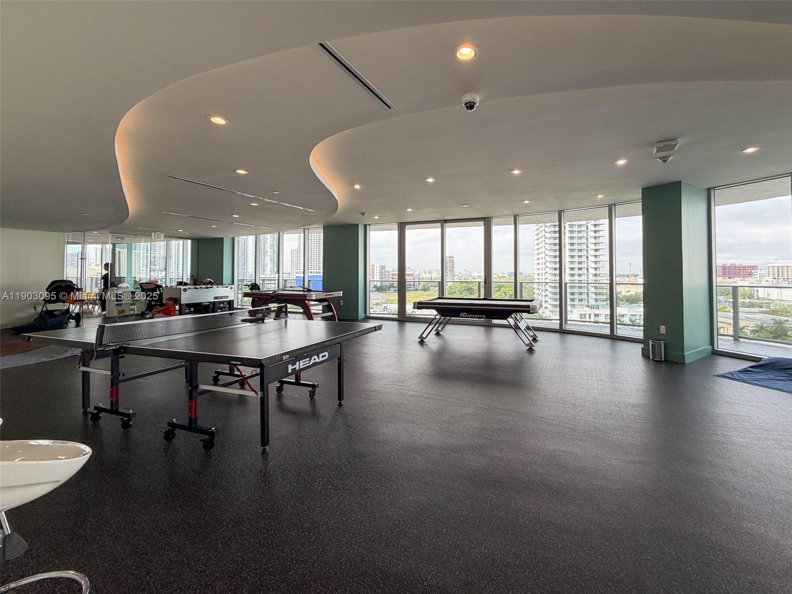 488 Northeast 18th Street, Unit 2301 Miami, FL 33132 - Photo 31 of 43 a lobby with furniture and a floor to ceiling window