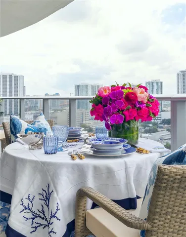 a dining table with chairs and white walls