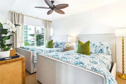 a living room with large window and furniture