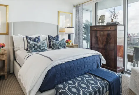 a bedroom with a bed and a mirror