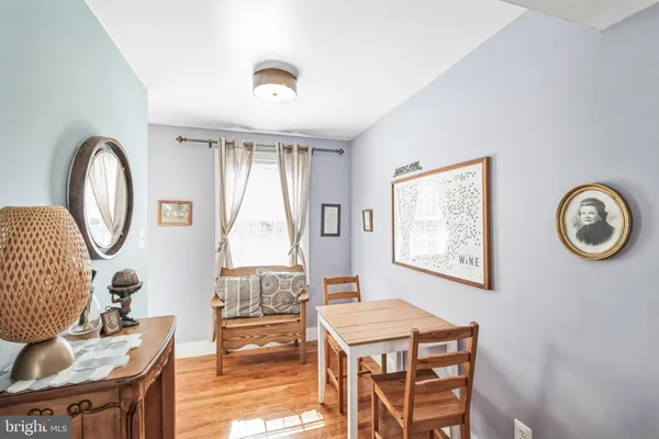 a living room with furniture a table and a large window