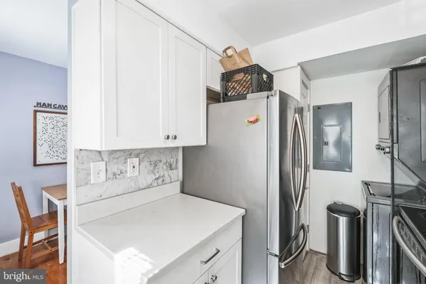 a kitchen with stainless steel appliances a refrigerator and a stove