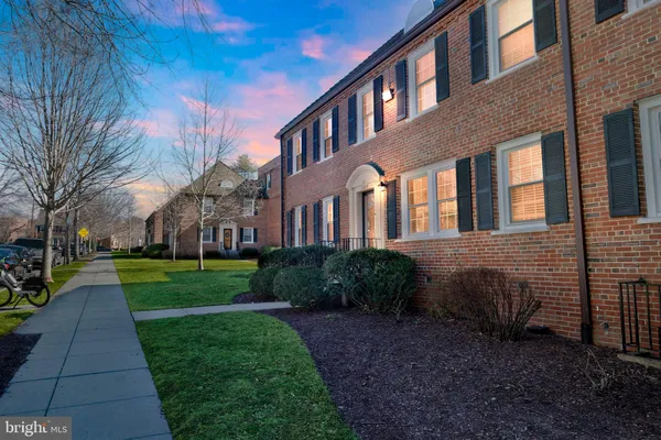 a view of a brick building next to a yard
