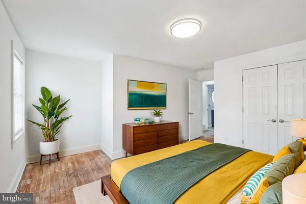 a bedroom with a bed and a potted plant