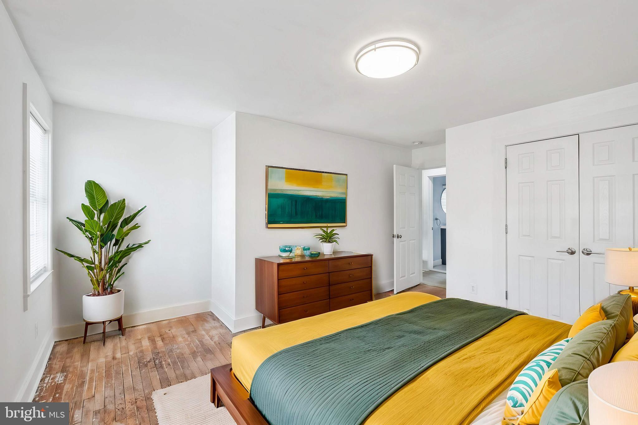 3805 V Street Southeast Washington, DC 20020 - Photo 24 of 31 a bedroom with a bed and a potted plant