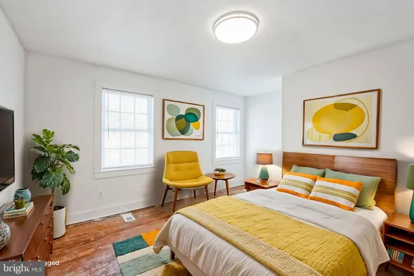 a bedroom with 2 bed and a potted plant